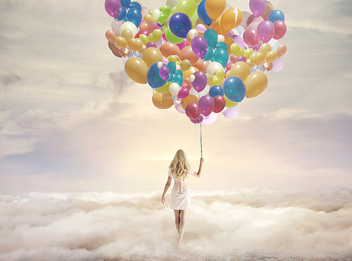 Conceptual picture of a woman holding hundreds of colorful balloons