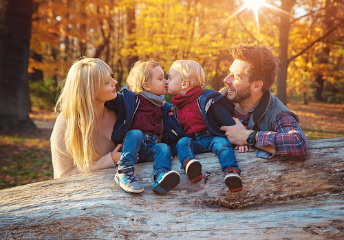 Cheerful family enjoying an autumn weather in a forest