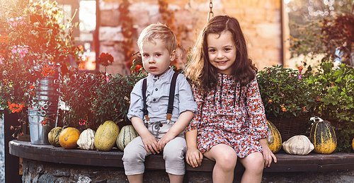 Portrait of little siblings on an autumnal farm