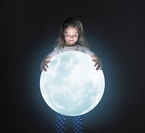 Art portrait of a cute little girl holding a shining moon