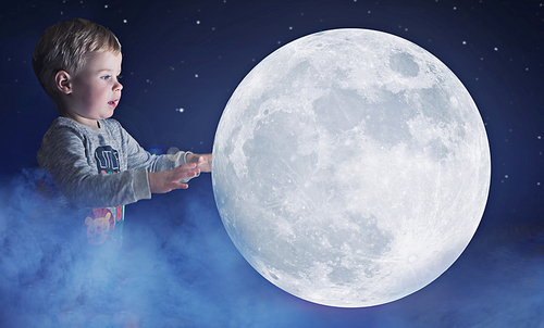 Art portrait of a cute, little boy holding a moon
