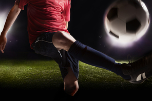 Soccer player kicking soccer ball