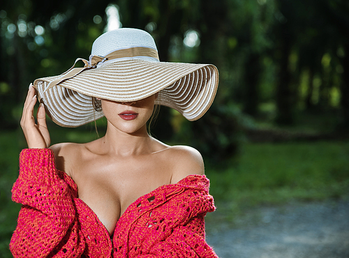Sensual blond woman wearing a straw hat