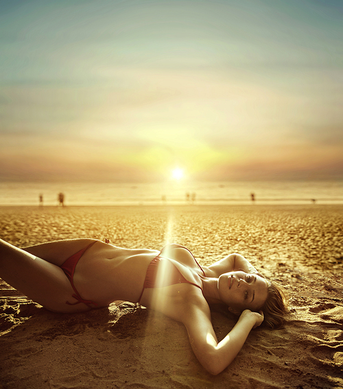 Portrait of a beautiful woman laying on a tropical beach