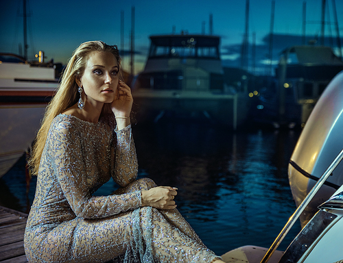 Elegant, beautiful woman resting in tropical port