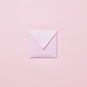Empty handmade envelope for congratulation card on a light pink background with copy space. Mockup.