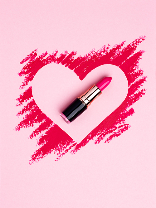 Valentine's Day background. Red and pink lipstick smeared in the shape of heart. Isolated on pink background. Cosmetic products