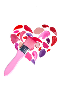 Valentine's Day background. Red and pink lipstick smeared in the shape of heart. Isolated on white background. Cosmetic brushes