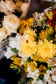 bouquet of soft pink roses and yellow daisies in wedding decor