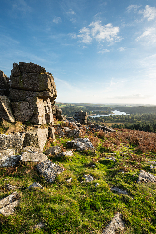 Beautiful Autumn sunset landscape image of view from Leather Tor towards Burrator Reservoir in Dartmoor National Park