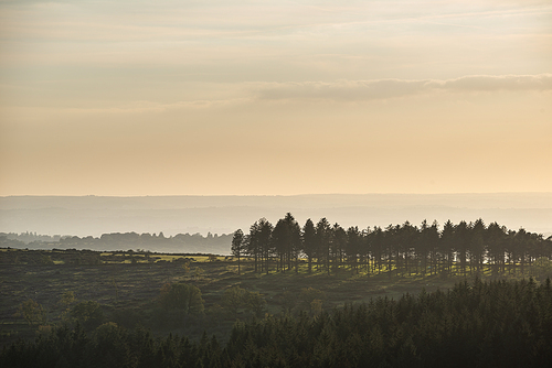 Beautiful Autumn sunset landscape image of view from Leather Tor in Dartmoor National Park