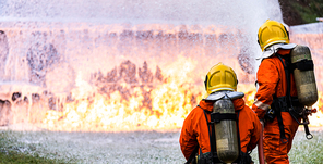 Panoramic Firefighter using Chemical foam fire extinguisher to fighting with the fire flame from oil tanker truck accident. Firefighter safety disaster accident and public service concept.