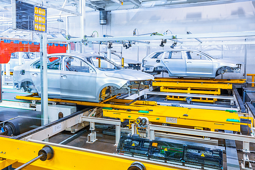 Assembling cars on conveyor line in car plant