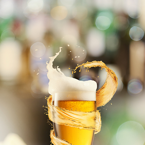 A cold glass of beer with beer foam and splash around on a blurred background with many colored bokeh