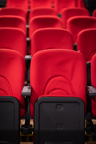 empty conference,theater or cinema hall with rows of red seats