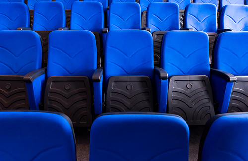 empty conference,theater or cinema hall with rows of blue seats
