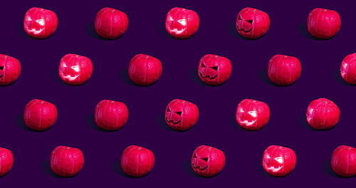 Halloween pumpkins Jack o'Lantern on purple background.