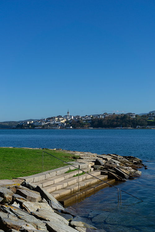 A view of Castropol in Asturias across the Ribadeo River with the Praia dos Bloques in the foreground