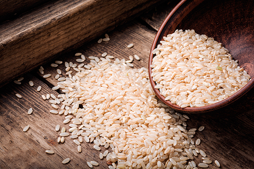 Raw grain white rice in a ceramic bowl.Healthy food.