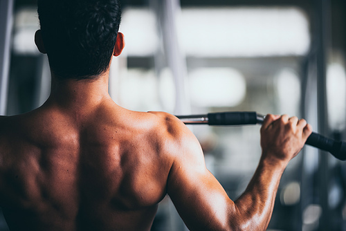 young fitness person execute exercise with exercise-machine in gym