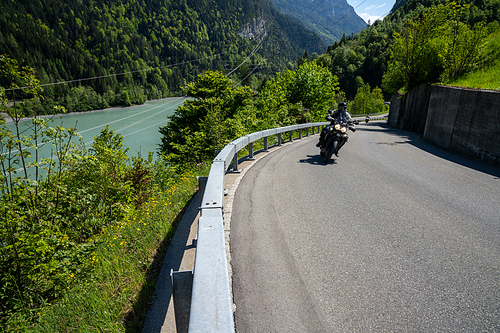 10 May 2020 - Vaettis , SG / Switzerland: a motorcycle rider enjoys a ride on the curving mountain roads in the idyllic Swiss Alps