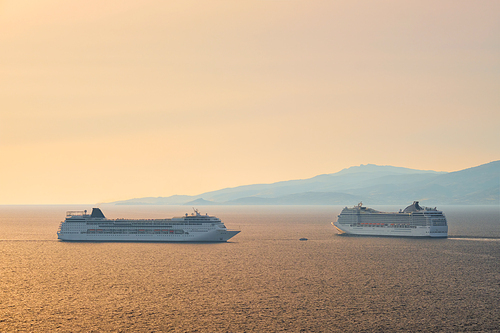 Cruise ships in Aegean sea on sunset. Mykonos island, Greece