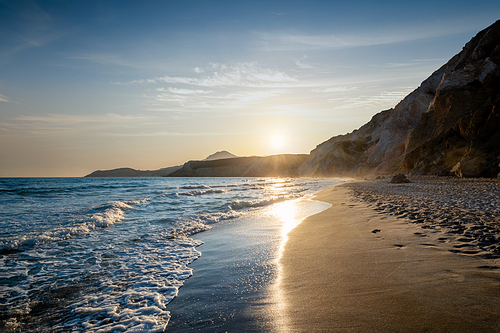 Fyriplaka beach and waves of Aegean sea on sunset, Milos island, Cyclades, Greece