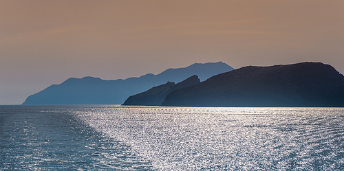 Cyclades greek islands silhouettes in Aegean sea. Greece