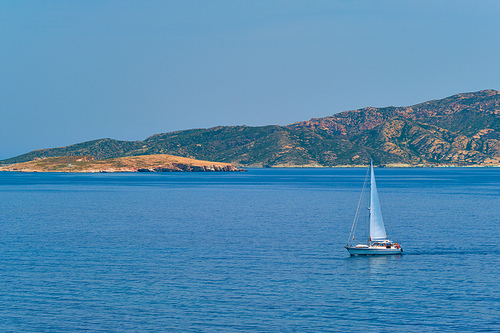 Yacht boat in blue waters of Aegean sea near Milos island , Greece