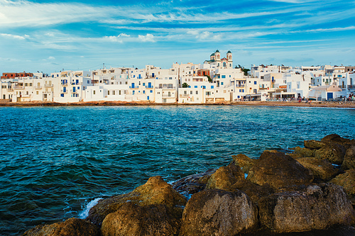 Picturesque view of Naousa town with greek orthodox church in famous tourist attraction Paros island, Greece with traditional whitewashed houses