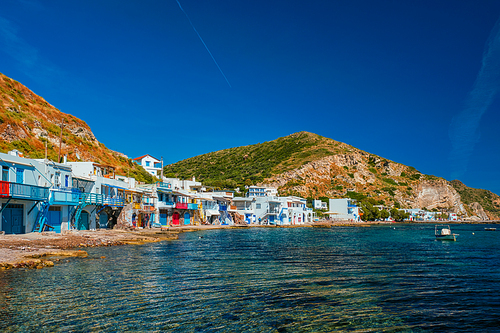 Scenic picturesque greek fishing village Klima with whitewashed traditional houses and colorful windows and doors on Milos island in Greece