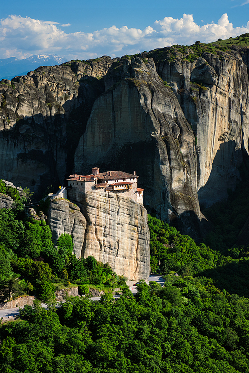 Monastery of Rousanou in famous greek tourist destination Meteora in Greece on sunset with scenic landscape.