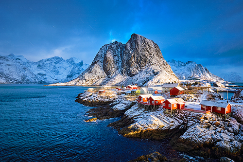 Famous tourist attraction Hamnoy fishing village on Lofoten Islands, Norway with red rorbu houses in winter