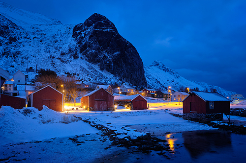 Ramberg village with red traditional rorbue houses in the night. Ramberg, Flakstad, Nordland, Norway