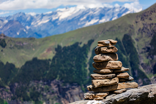 Stone cairn in Himalayas with mountains in background. Near Manali, above Kullu Valley, Himachal Pradesh, India