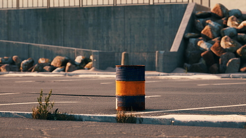 old and rusty metal barrel on parking