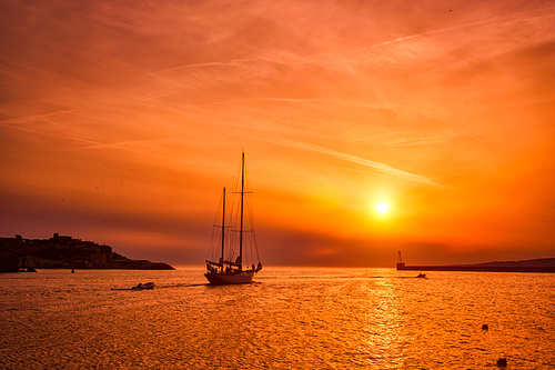 Ship schooner boat sihouette in port of Marseille on sunset. Marseille, France