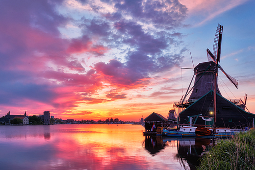 Netherlands rural scene - - windmills at famous tourist site Zaanse Schans in Holland on sunset with dramatic sky. Zaandam, Netherlands