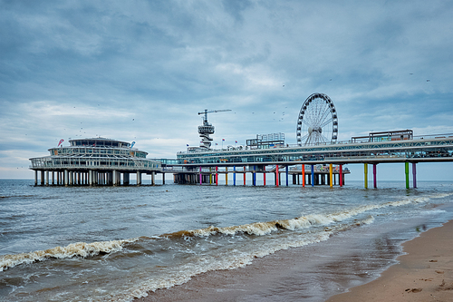 The Scheveningen Pier Strandweg, beach resort on North sea in The Hague Den Haag with Ferris wheel. The Hague, Netherlands