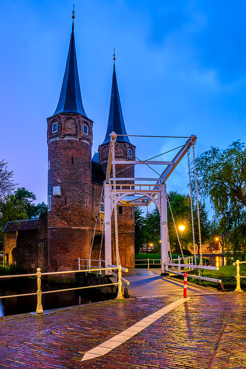 Oostport (Eastern Gate) of Delft with drawbridge in night. Delft, Netherlands