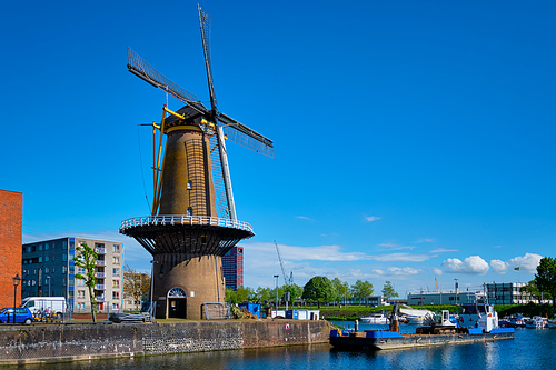 View of the harbour of Delfshaven with the old grain mill known as De Destilleerketel. Rotterdam, Netherlands