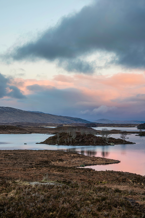 Beautiful colorful Winter sunrise landscape image across Rannoch Moor in Scottish Highlands