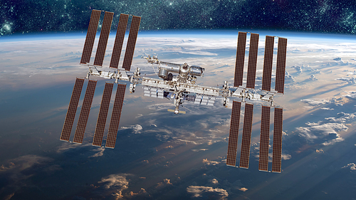 International Space Station over the planet earth. Elements of this image furnished by NASA.
