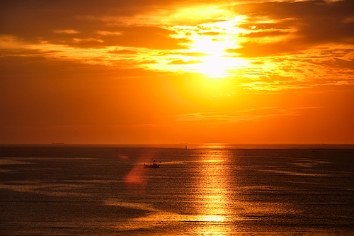 Ocean sunset with boats in sea. Mumbai, India