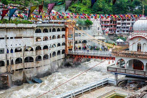 Sikh Gurdwara, bridge over Parvati river and hot springs in Manikaran Sikh sacred site in Himalayas. Himachal Pradesh, India