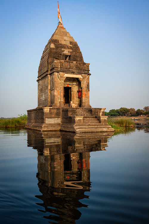 Baneswar temple (Small Hindu temple dedicated to Shiva) in the middle of the holy Narmada River, Maheshwar, Madhya Pradesh state, India