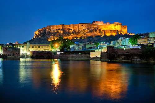 Famous indian tourist landmark Mehrangarh fort in the evening view over Gulab Sagar lake. Jodhpur, Rajasthan, India