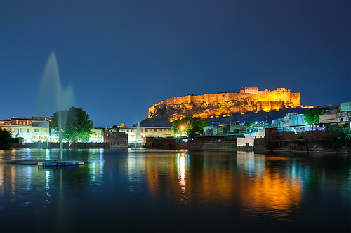 Famous indian tourist landmark Mehrangarh fort in the evening view over Gulab Sagar lake. Jodhpur, Rajasthan, India