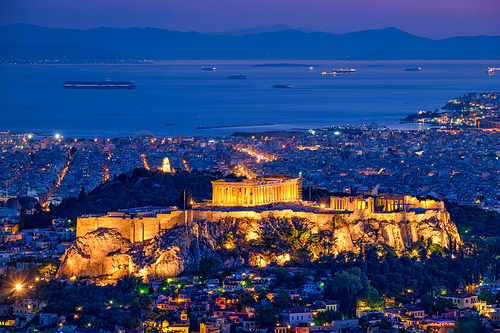 Parthenon Temple on hill is the antique tourist landmark at the Acropolis of Athens and ancient European civilization architecture on Aegean sea coast. Dusk view from Mount Lycabettus, Athens, Greece