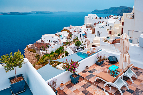 Famous greek iconic selfie spot tourist destination Oia village with traditional white houses and windmills in Santorini island, Greece